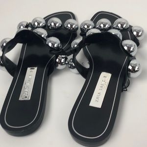 black slides with silver balls